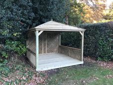 wooden gazebo with deck and trellis sides